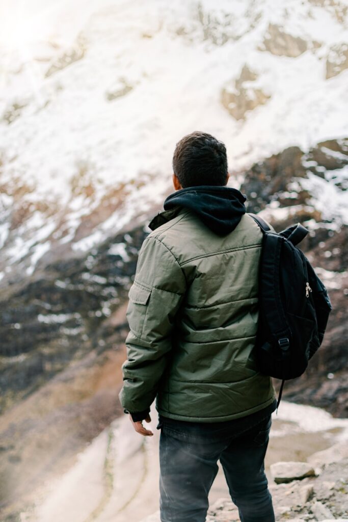 man facing mountain covered with snow